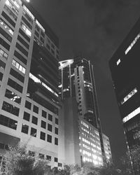 Low angle view of modern building against sky at night