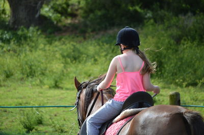 Rear view of man riding horse