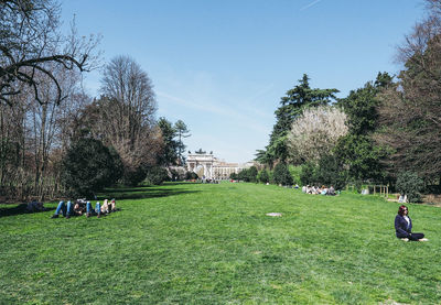 People on field against sky
