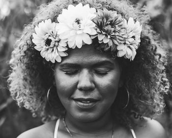 Close-up portrait of woman with pink flower