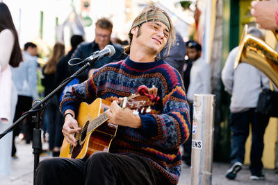 Man playing guitar on street