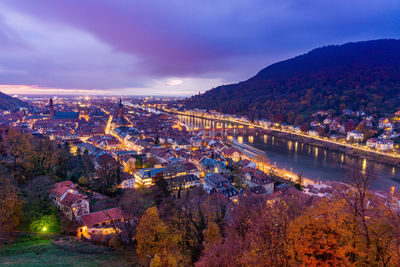 High angle view of illuminated buildings in city at dusk