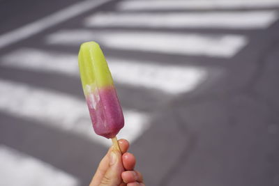 Close-up of hand holding ice cream