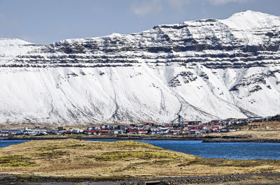 View across hills and bodies of water towards the town against a spectacular backdrop 