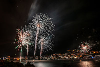 Low angle view of firework display at night