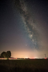 Scenic view of field against sky at night