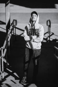 Portrait of young man standing on staircase