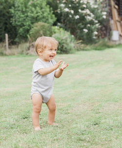 Cheerful boy on grassy field