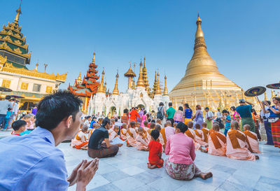 Group of people outside temple against building