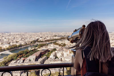 Rear view of woman looking at cityscape