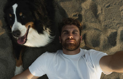 Man taking a selfie with his dog person