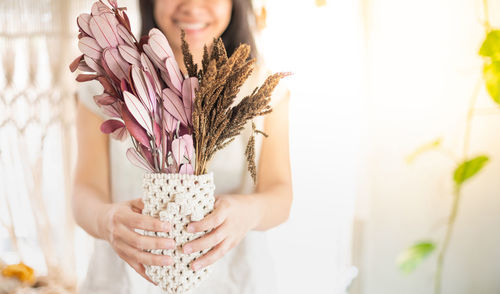 Close-up of woman holding flowers