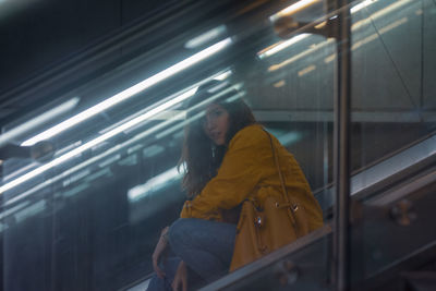 Young woman on escalator