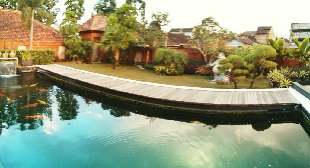 reflection, water, architecture, building exterior, built structure, tree, waterfront, standing water, lake, pond, sky, house, canal, day, swimming pool, outdoors, nature, no people, residential building, growth