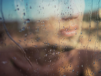 Man behind wet window