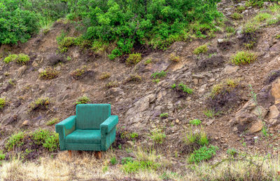 High angle view of abandoned sofa on field