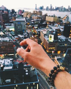 Hand pointing towards cityscape