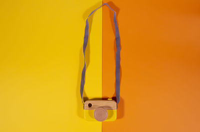 Close-up of yellow electric lamp against orange background
