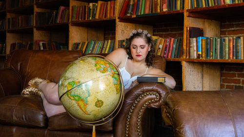 Portrait of young woman sitting on chair