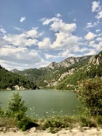 Scenic view of lake and mountains against sky