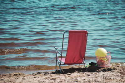 Chair on shore at beach