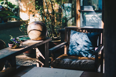 Close-up of chair and woman sitting on table