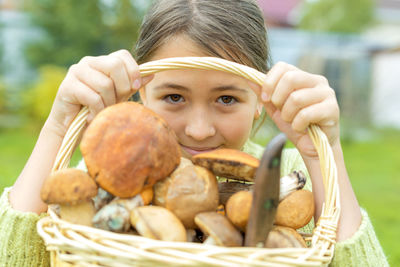 Portrait of girl holding ice cream in basket