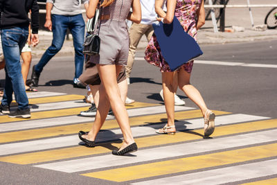 Low section of people walking on road