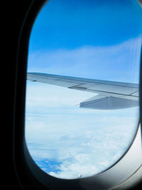 Scenic view of cloudscape seen through airplane window