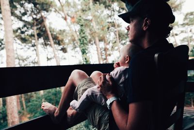 Father with daughter sitting outdoors