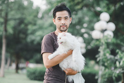 Portrait of man standing against blurred background
