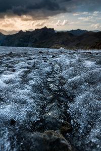 Scenic view of rocks in winter against sky