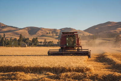 Tractor on land against clear sky