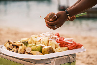 Cropped hand of man preparing food