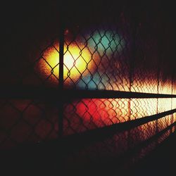 View of chainlink fence at sunset