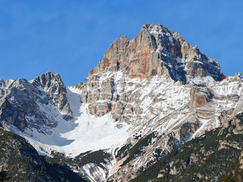Scenic view of snowcapped mountains against clear blue sky