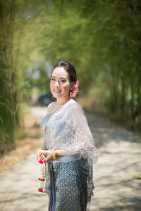 Portrait of a smiling young woman standing outdoors