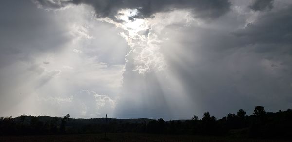 Low angle view of storm clouds over landscape