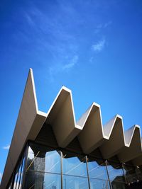 Low angle view of modern building against blue sky