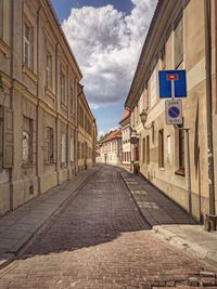 Empty road amidst buildings in town