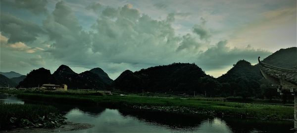 Scenic view of lake by trees against sky