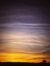 Silhouette of windmill against sky during sunset