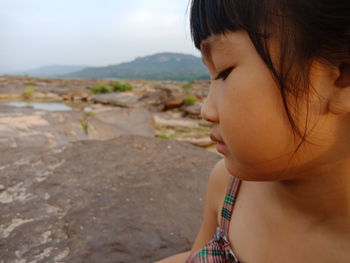 Close-up of cute girl looking away