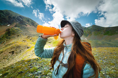 Profile photo of a young beautiful woman with long hair, wearing a jacket and a panama hat with a