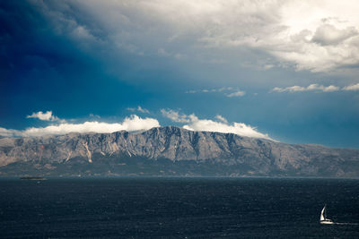 Scenic view of sea against cloudy sky