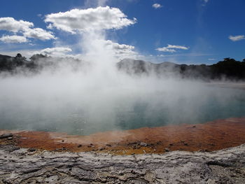 Smoke emitting from geyser against sky