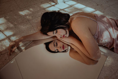 High angle portrait of woman lying on floor