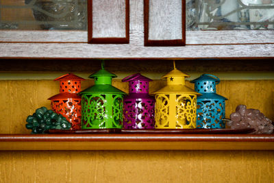 Multi colored candles on shelf