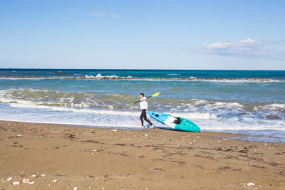 Man on beach against sky