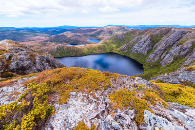 Scenic view of lake by mountain against sky